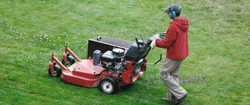 Our professional grade mower with one of our employees using it.